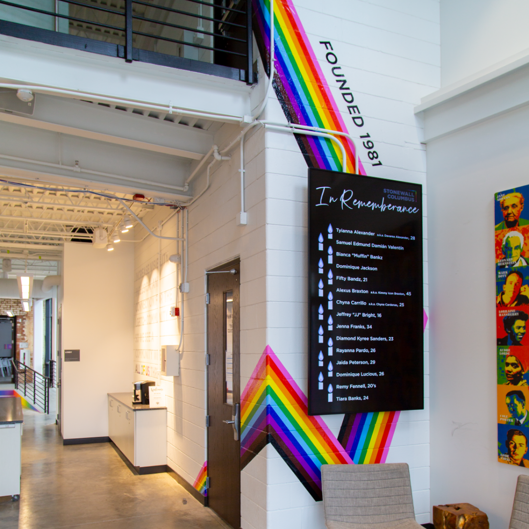 The front entry features a floor-to-ceiling rainbow graphic spanning two floors ainbow vinyl graphic at Stonewall Columbus Community Center by Continental Office Branding