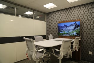 One of our “quick standup” rooms outfitted with a standing height table and a TV for sharing