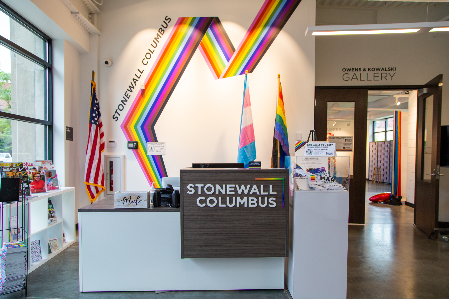 The front entry features a rainbow vinyl graphic that helps bring this space to life at Stonewall Columbus Community Center by Continental Office Branding