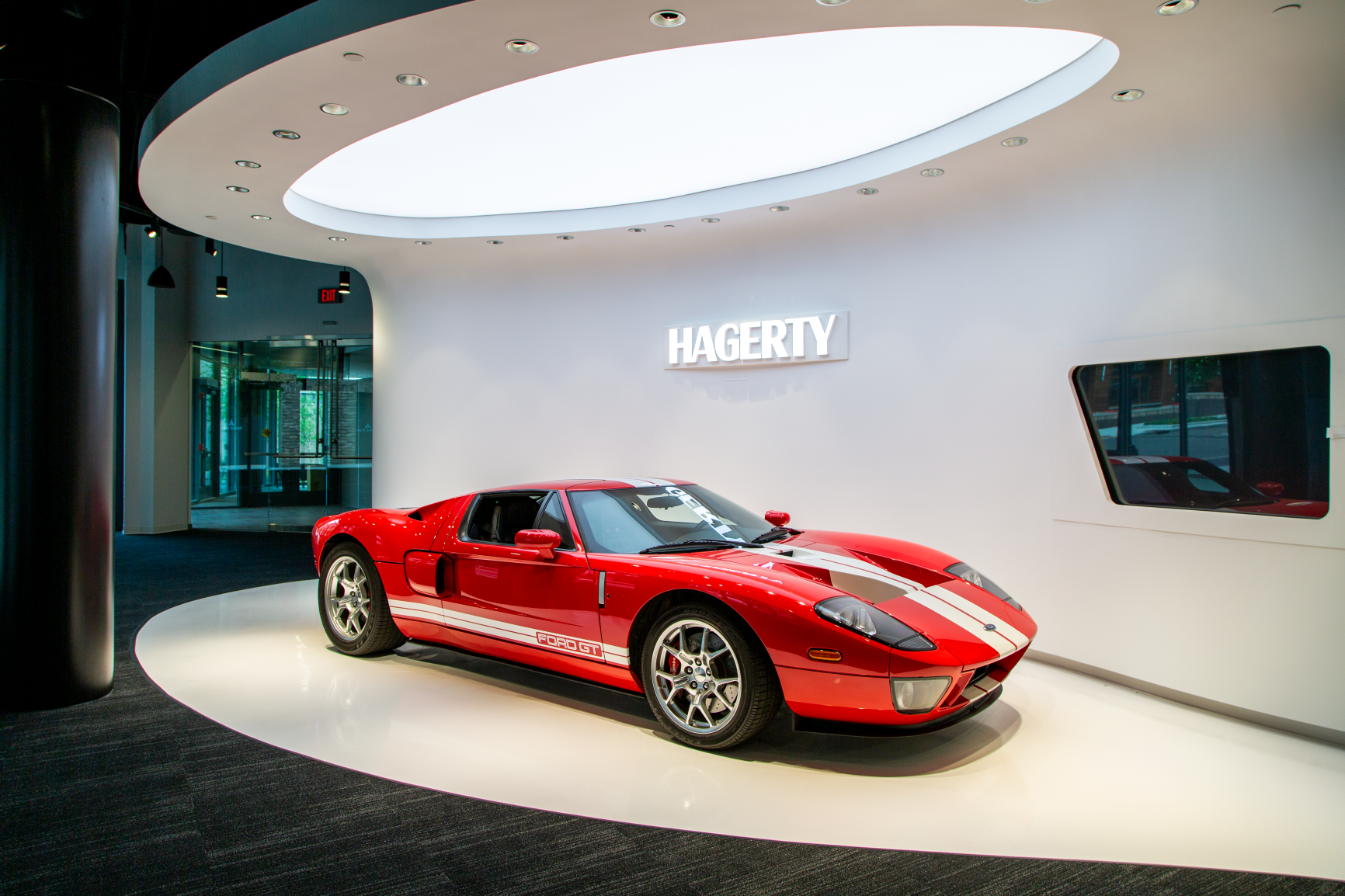 side view of red car front of hagerty