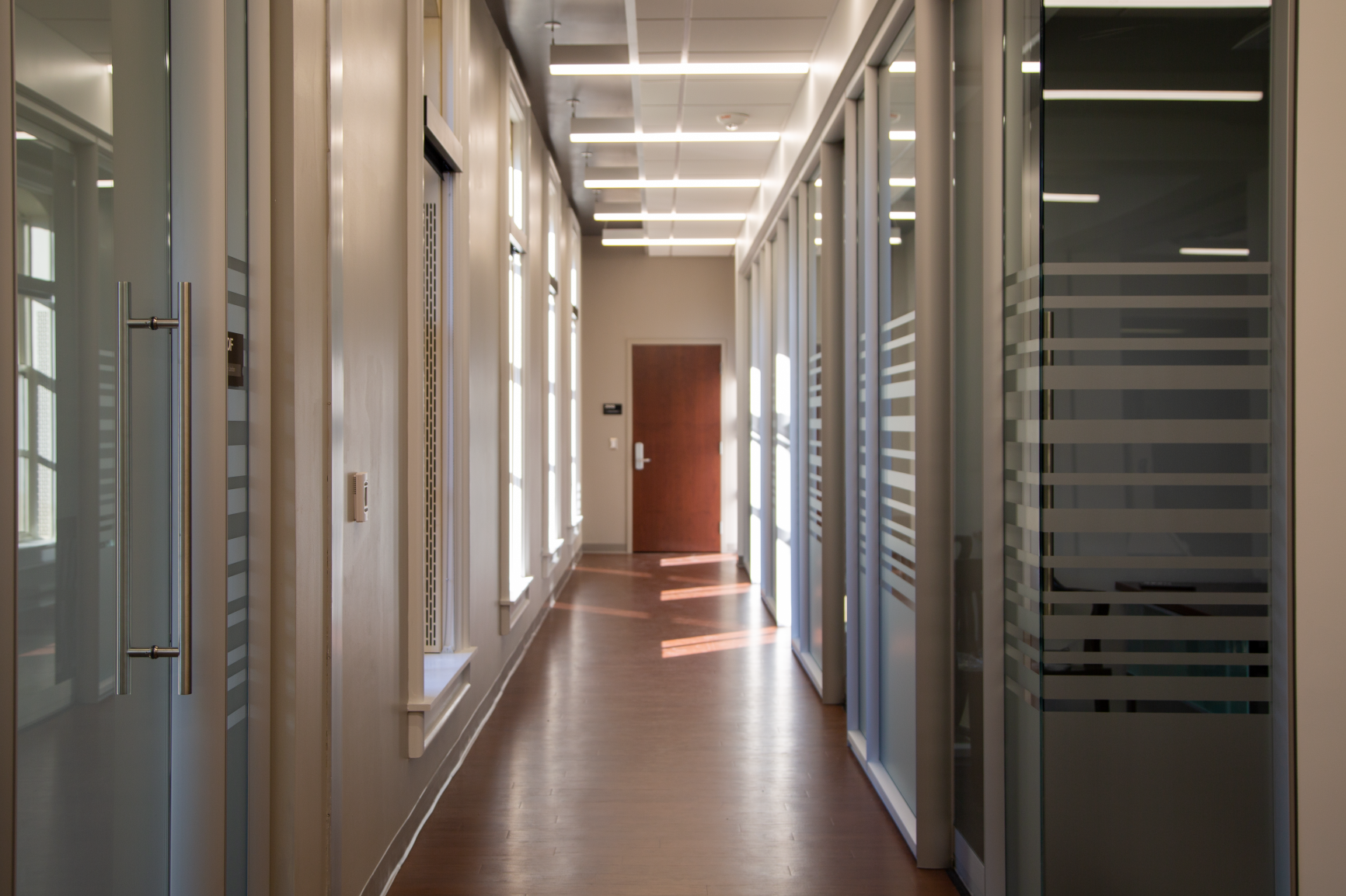 Private offices with DIRTT glass walls bring the sunlight in, leading to the classroom.