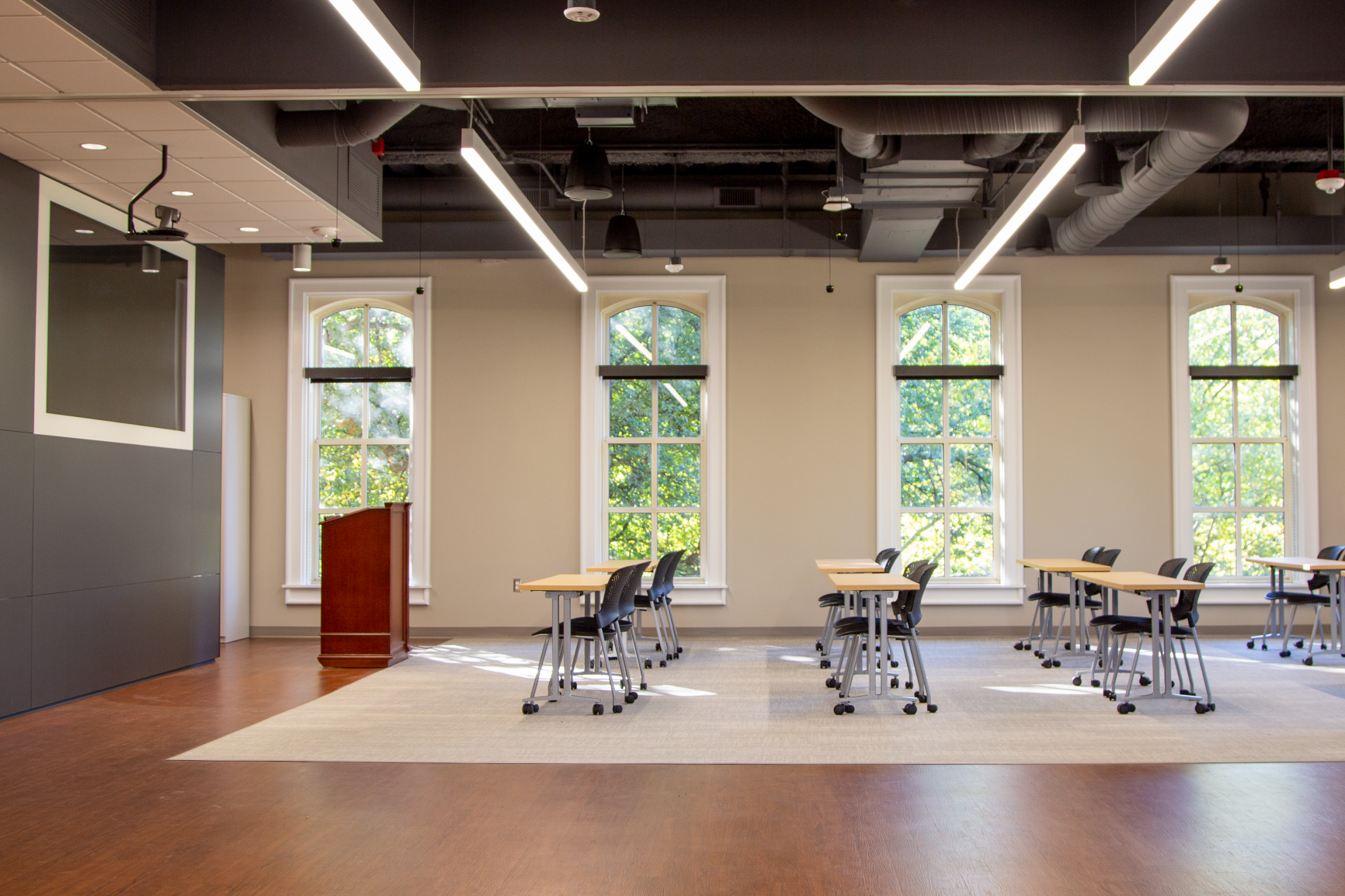 Durable wood-like flooring frames the carpeted classroom area and provides an easy-to-clean surface for the adjacent multipurpose space.