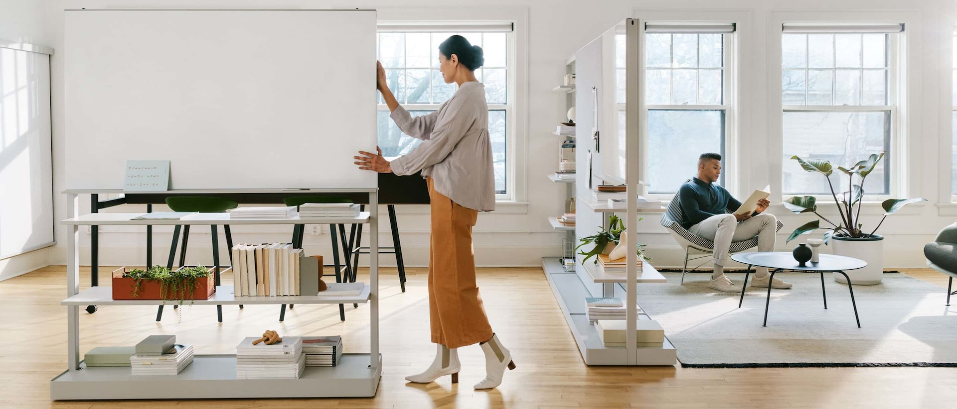 Workers rearranging the new Herman Miller OE1 collection for their work needs