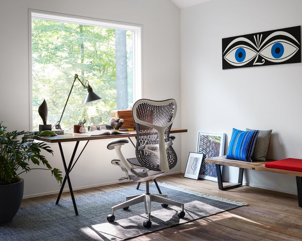 A grey Herman Miller Mirra 2 chair faces a window in a work from home office setup Continental Office