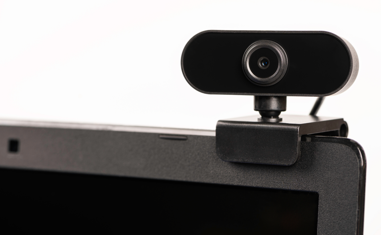 An auxiliary webcam sits atop a laptop to provide better picture quality for viewers on a video call